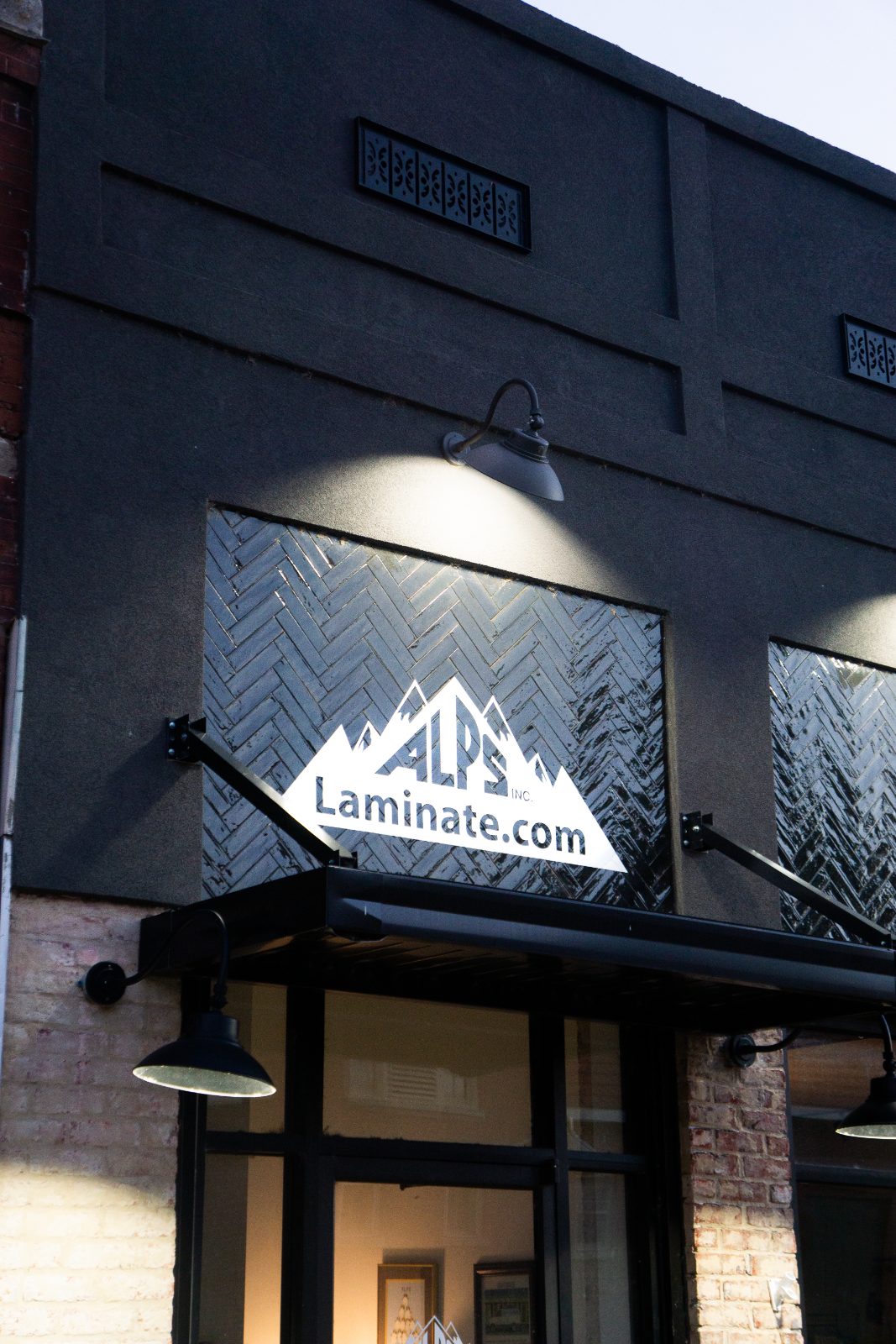 ALPS Laminate.com blade sign against the herringbone tile transom panel