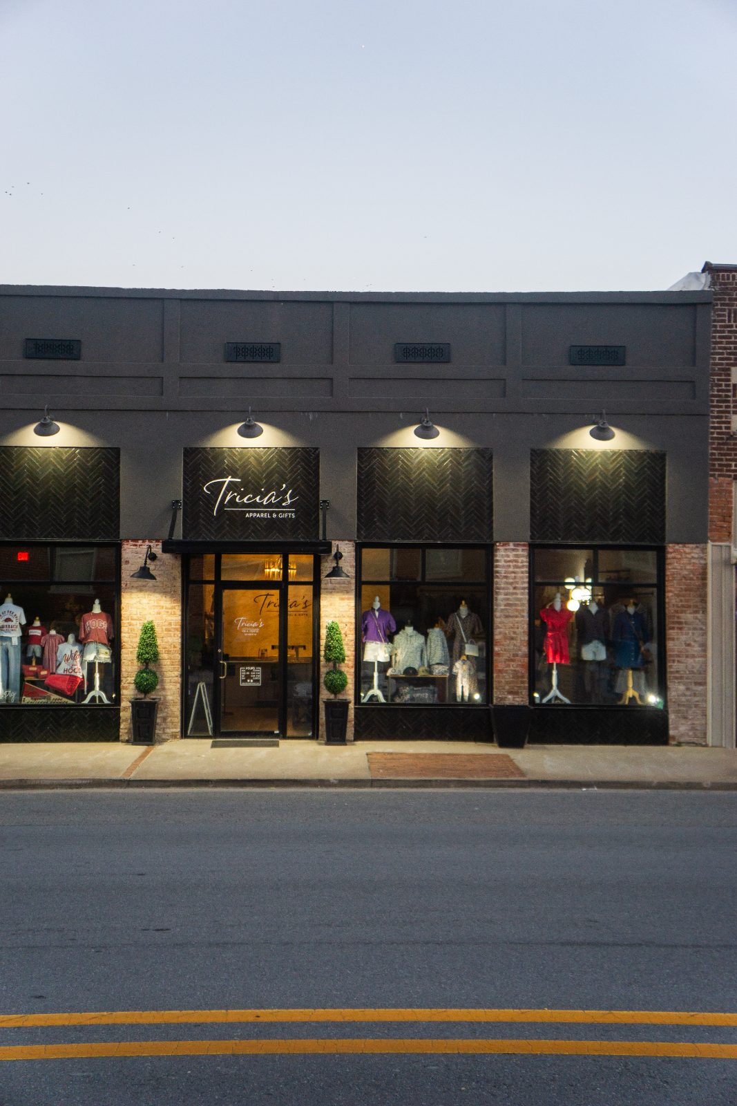 Tricia's Apparel & Gifts storefront with lit display windows