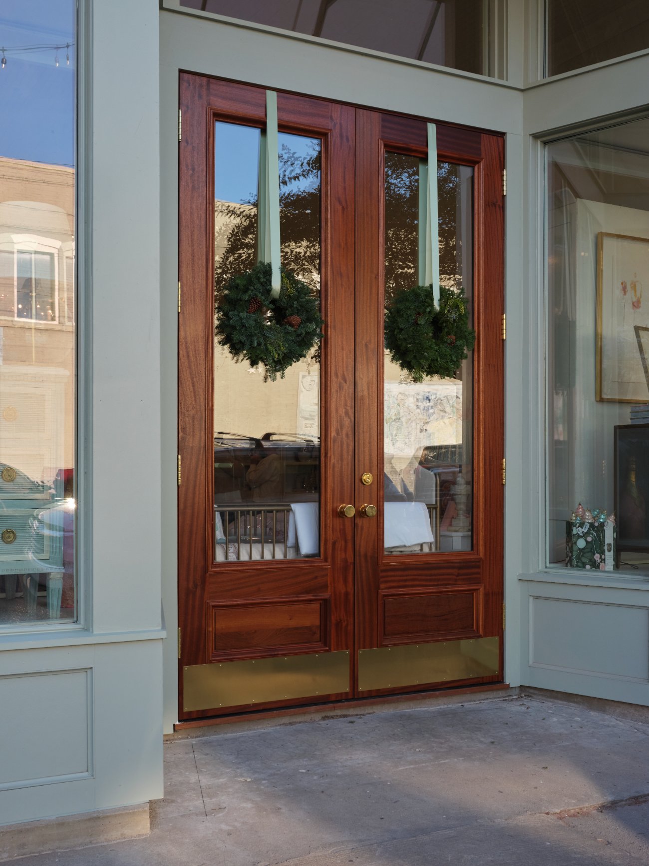 Mahogany double doors with brass kickplates and wreaths