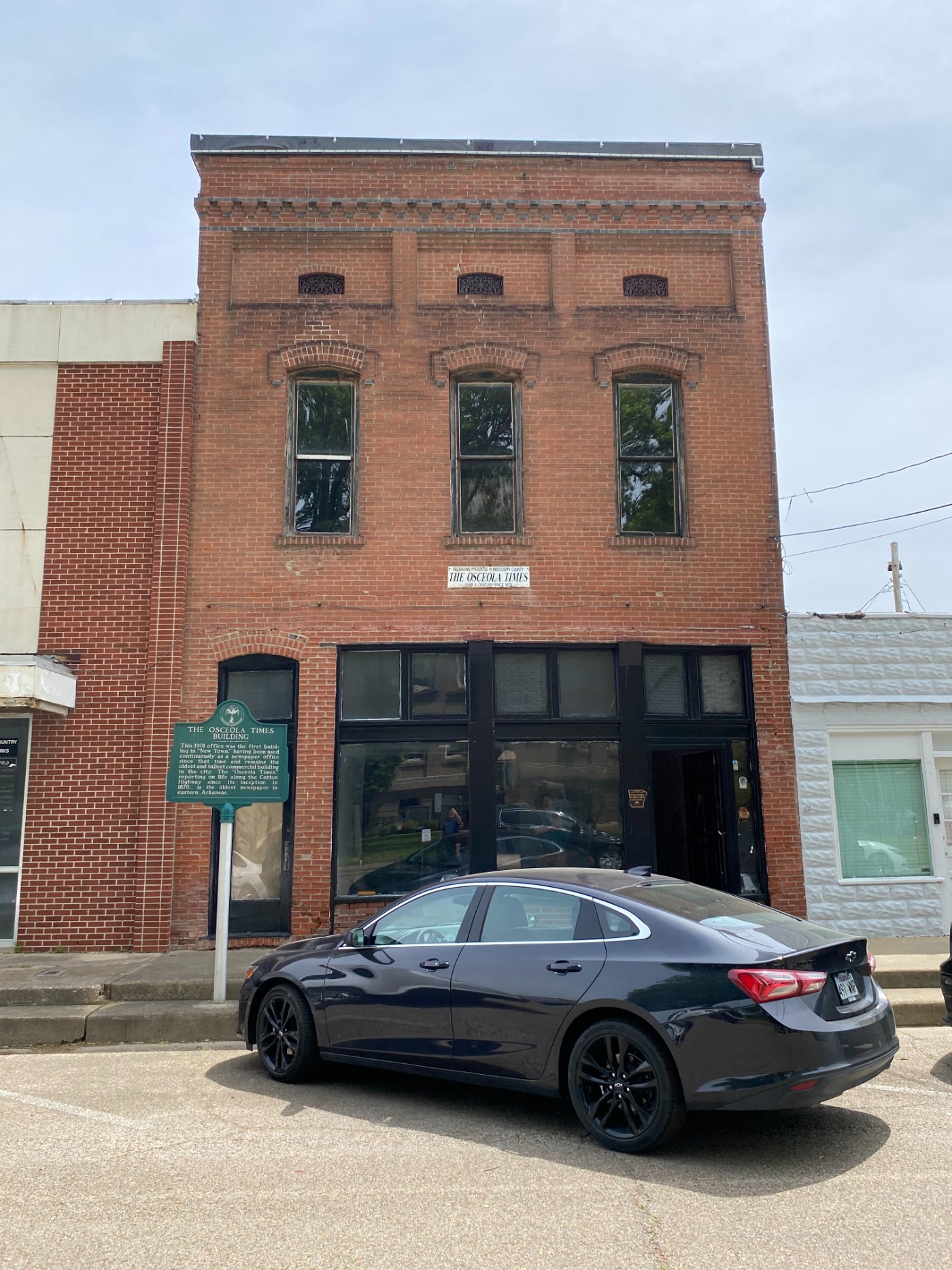 The Osceola Times Building in 2023, brick facade with historical marker at the sidewalk