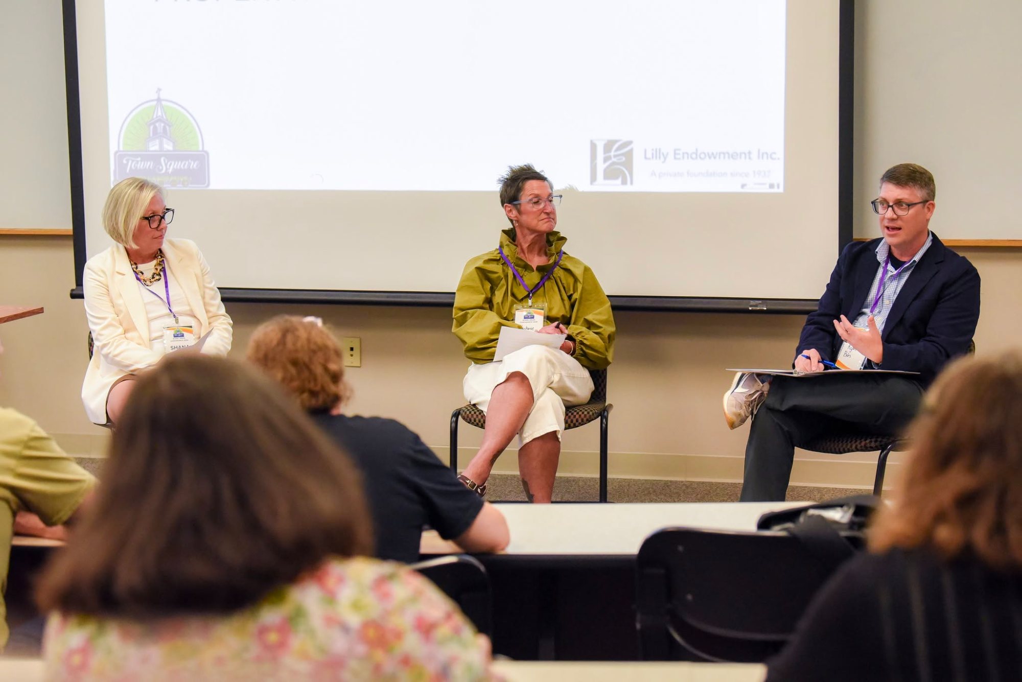 Ryan Biles in a panel conversation with two other speakers in front of an audience
