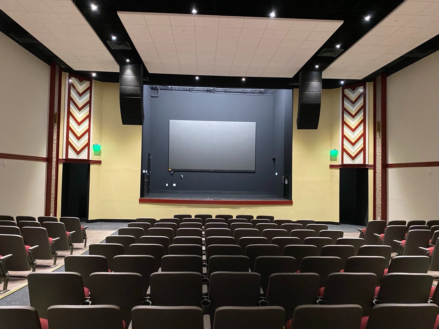 The auditorium looking toward the stage, with restored chevron wall detail and new seating