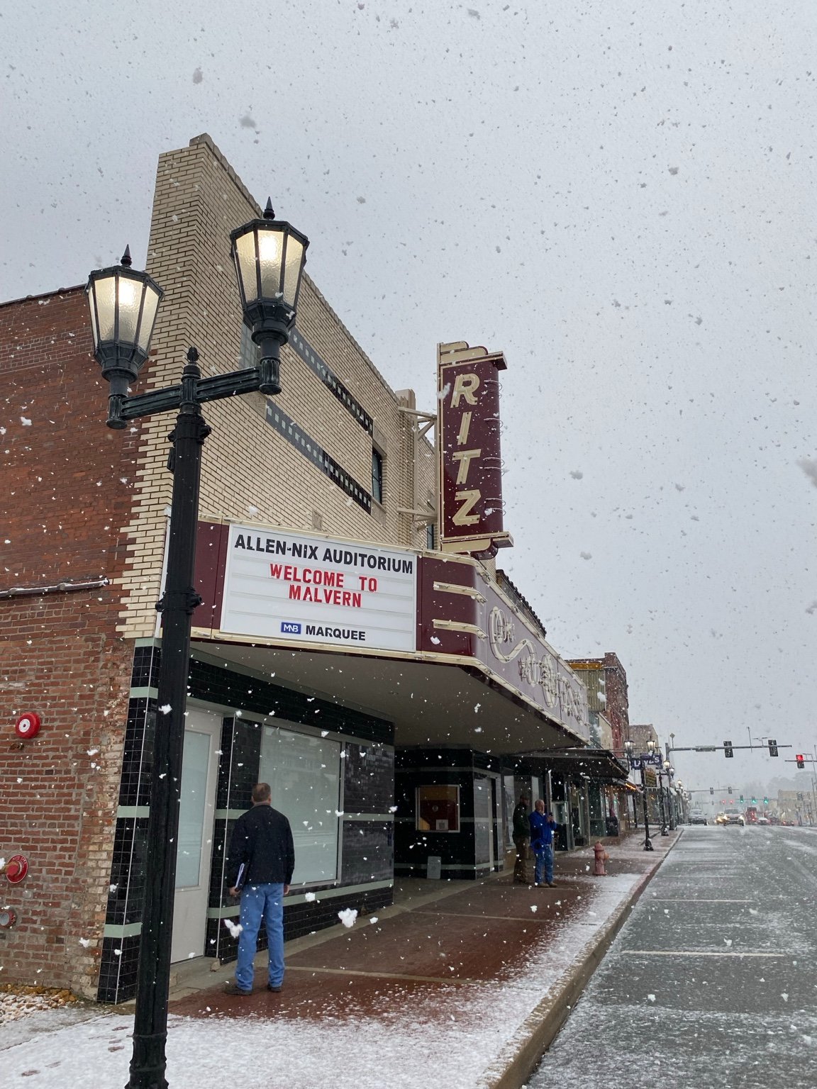 The restored Ritz marquee and neon blade sign on Main Street during a snowfall
