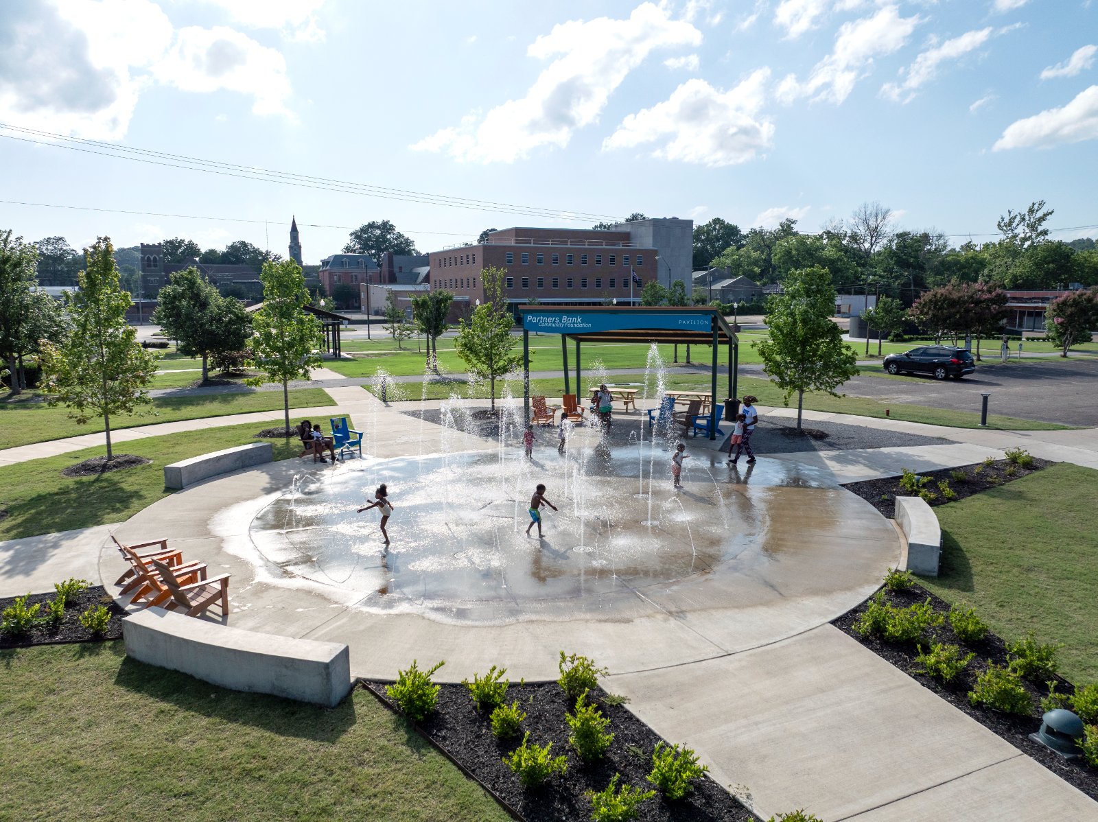 Aerial view of the circular splash pad, pavilion, and surrounding walks